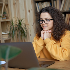 a girl watching a video on a laptop
