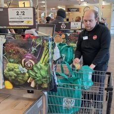 Brian loading grocery bags into cart at his job placement, Big Y