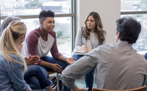 group of teens talking in circle