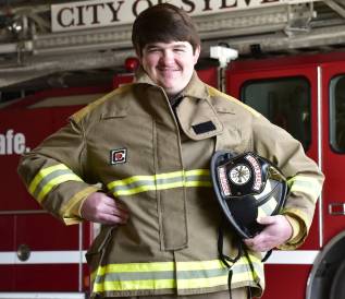 Participant standing in front of fire truck