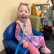 Girl sitting in a chair smiling