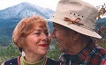 A couple looks at each other outdoors