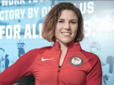  Amanda McGrory in a red athletic jumpsuit and an American pin
