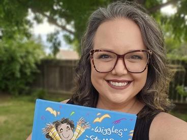 Lindsey Rowe Parker holding up her book