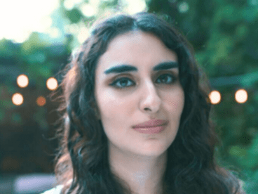 Rawan Tuffaha outside in a soft, calming place with trees and lights