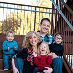 Fryar family photo, mom and dad with 3 young children, sitting on stairs