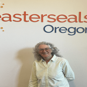 An older woman standing in front of the Easterseals Oregon sign