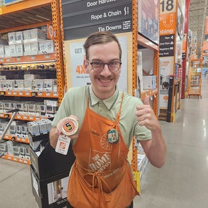 Employee of Home Depot giving a thumbs up 
