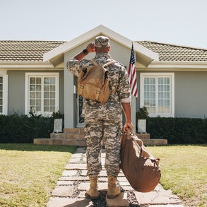 Veteran standing in front of house