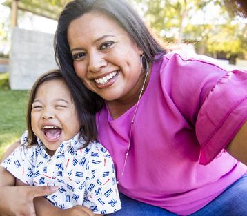 A mom taking a selfie with her son who has Down Syndrome