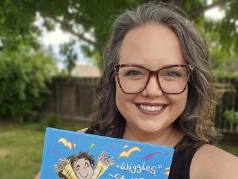 Lindsey Rowe Parker holding up her book