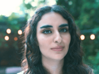 Rawan Tuffaha outside in a soft, calming place with trees and lights