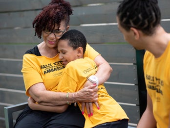walkathon fundraiser at which adult and child hug