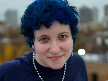 Liz with short blue hair, smiling