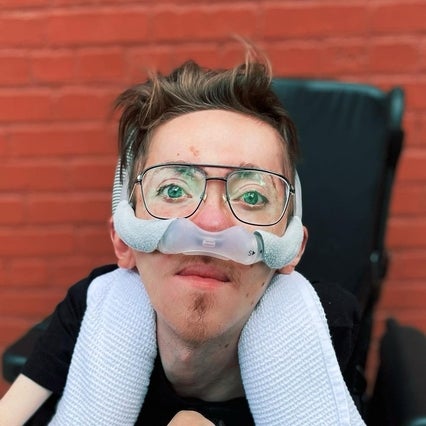 Steve Way sitting in his wheelchair, wearing glasses