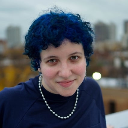 Liz with short blue hair, smiling