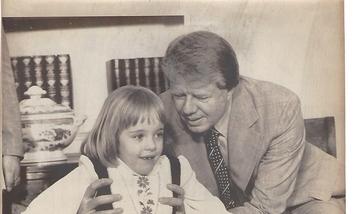 President Carter holds a child using braces