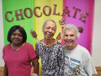 Three older women enjoying an event for seniors