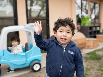 Child waving their hand