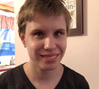 Alicia Krage headshot. Alicia a white woman smile at the camera. She has short brunette hair. 