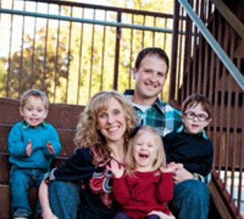 Fryar family photo, mom and dad with 3 young children, sitting on stairs