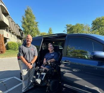 Rhonda on the lift into her van with her driver