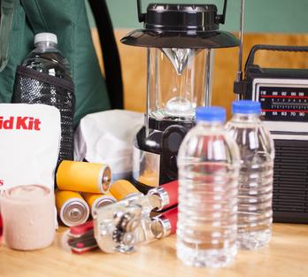 emergency kit including water, first aid kit, and a radio