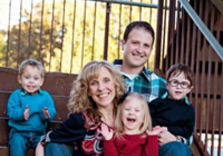 Fryar family photo, mom and dad with 3 young children, sitting on stairs