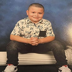 Photo of Junior sitting on a sideways column