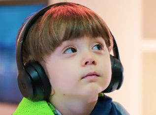 Boy with autism wearing headphones