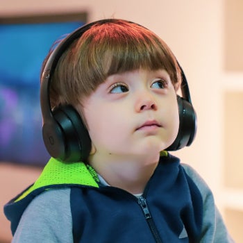 Boy with autism wearing headphones