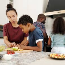 Family working together to cook meal