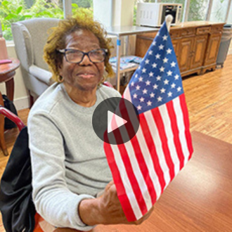 gladys smiling waving american flag