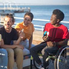 Young teen in wheelchair with friends