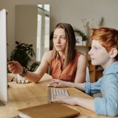 Woman and young boy on computer