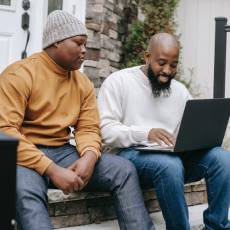 teenage boy with adult on laptop