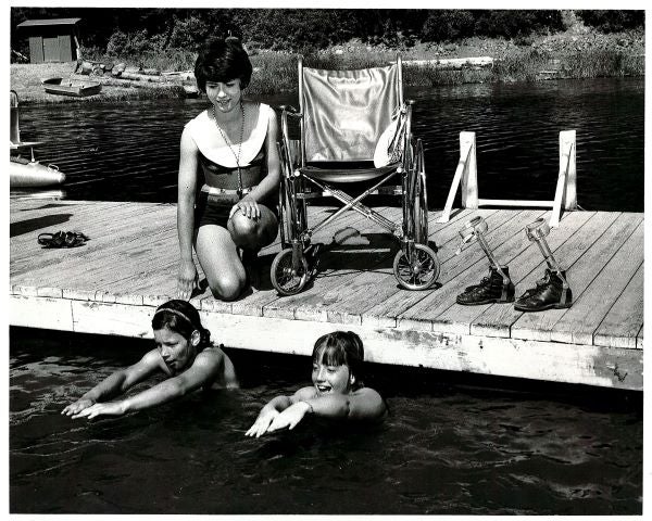 Black and white image of campers swimming in Vaughn Bay 