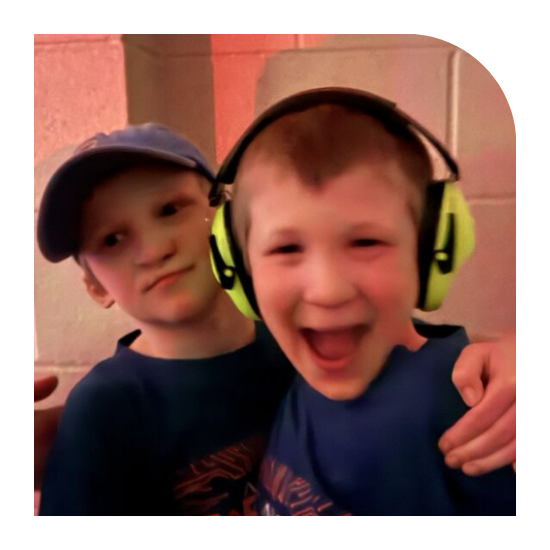 Harrison and Hudson posing together for a photo, they look joyful.