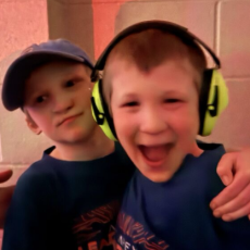 Harrison and Hudson posing together for a photo, they look joyful.